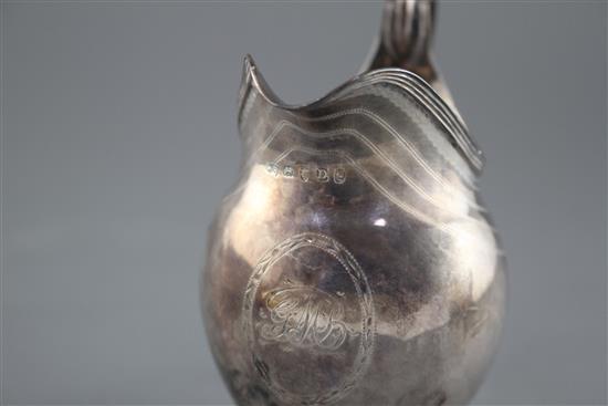 A George III engraved silver helmet shaped cream jug by George Burrows, London, 1799, height 11cm, 3.5oz.